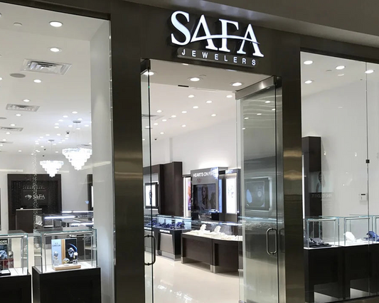 SAFA Jewelers store front with glass display cases and jewelry on shelves.